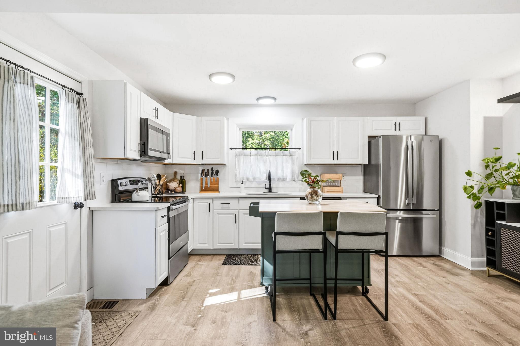 209 Myrtle Lane Berlin, NJ 08009 - Photo 9 of 36 a kitchen with refrigerator cabinets and wooden floor