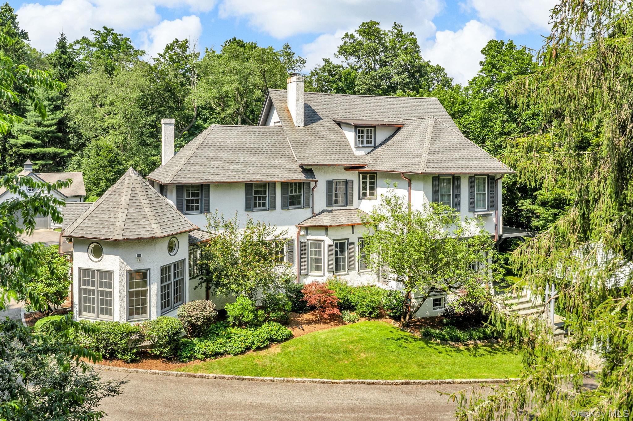a aerial view of a house with a yard and potted plants