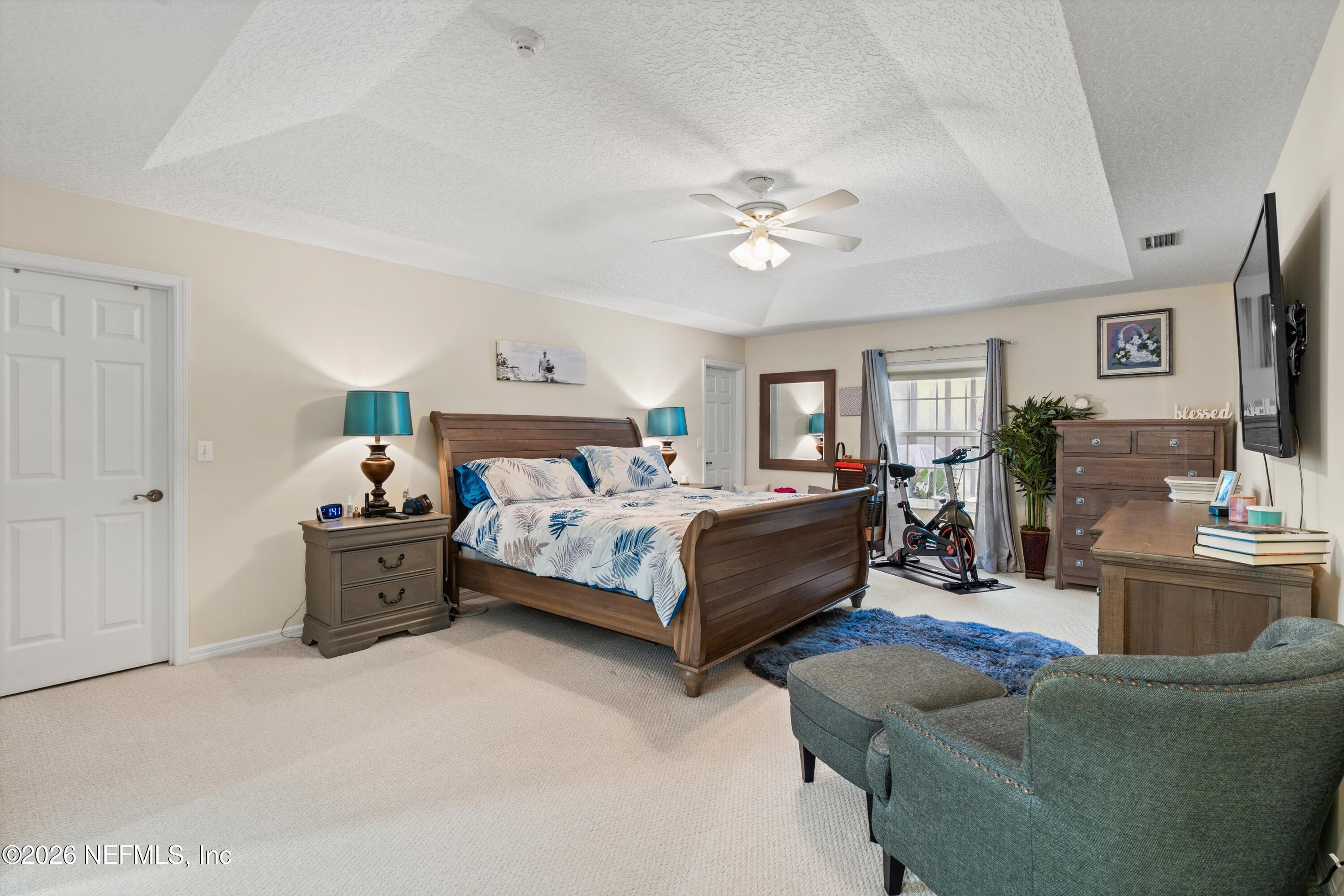 5566 Don Manuel Road Elkton, FL 32033 - Photo 18 of 47 a bedroom with a bed couch and window