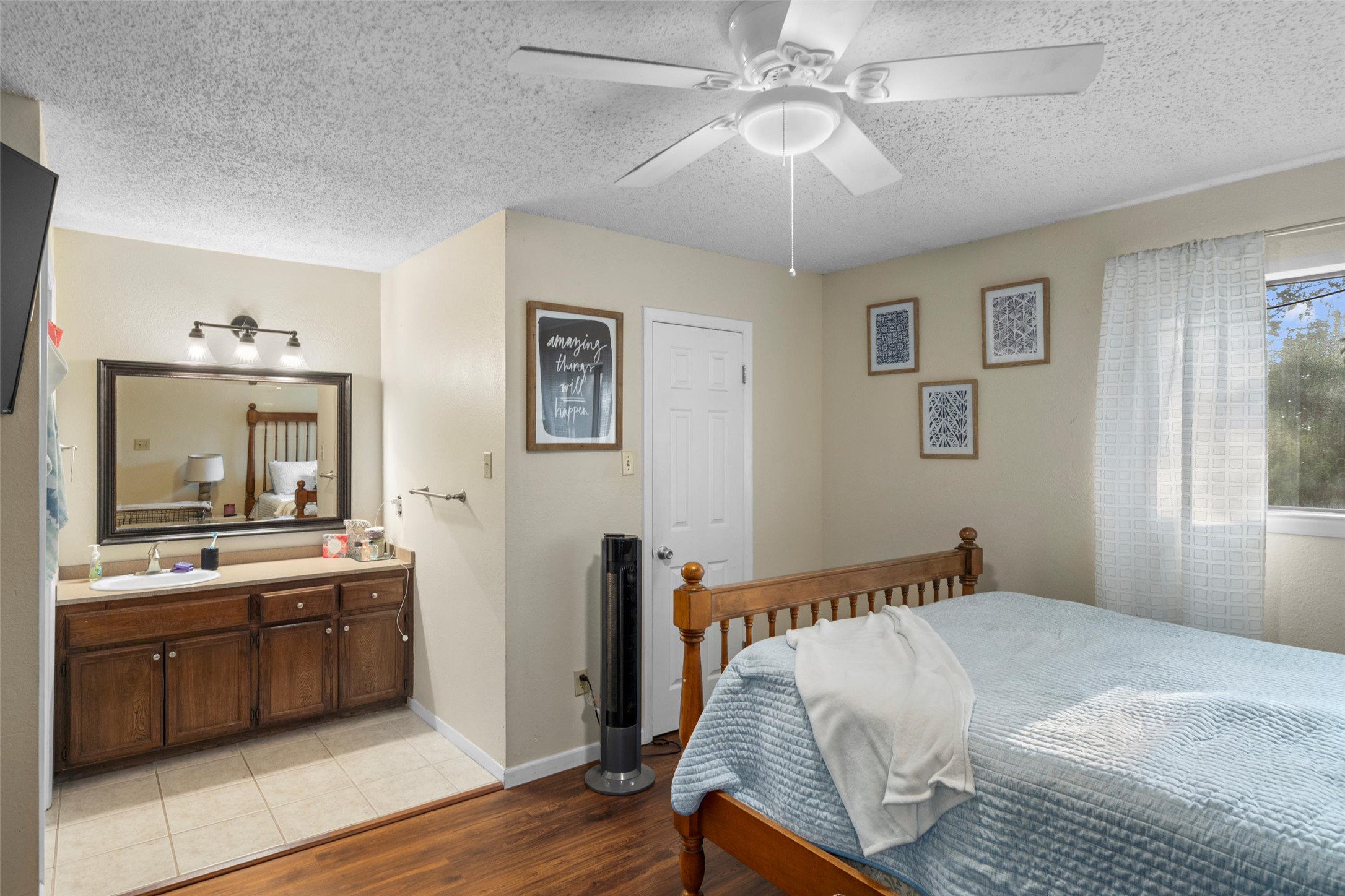 6492 Hart Lane Austin, TX 78731 - Photo 13 of 22 Bedroom with light wood-style flooring, a textured ceiling, and a ceiling fan