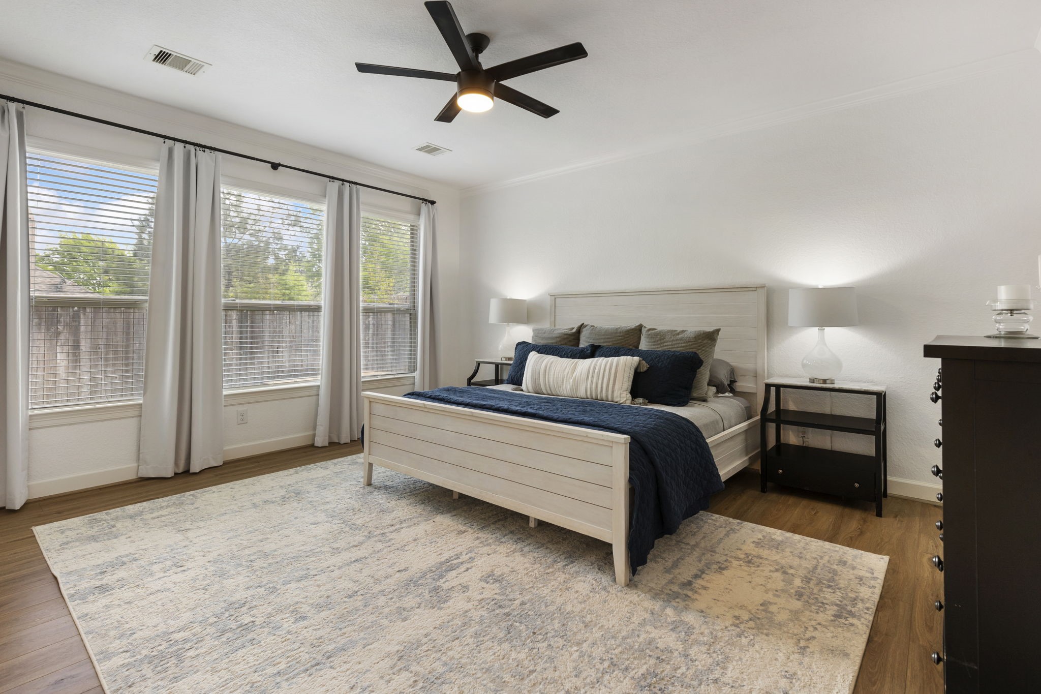 71 Sagamore Ridge Place The Woodlands, TX 77389 - Photo 22 of 34 a bedroom with a large bed and a large window
