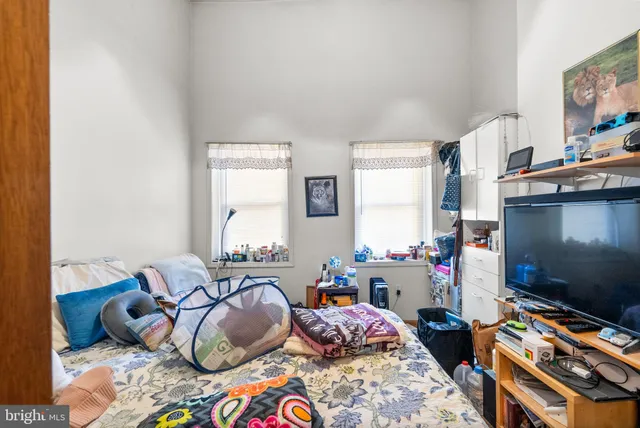 a bedroom with furniture and a flat screen tv
