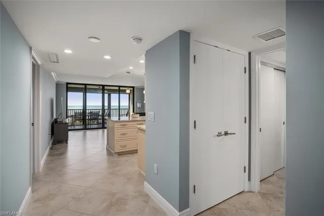 a large white bathroom with a tub shower and fireplace