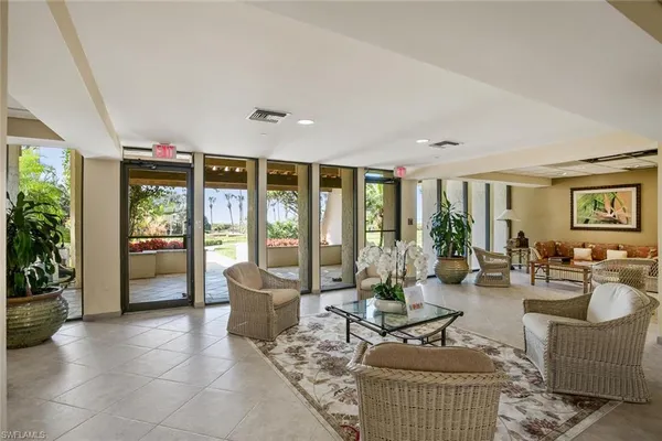 a living room with furniture and large windows