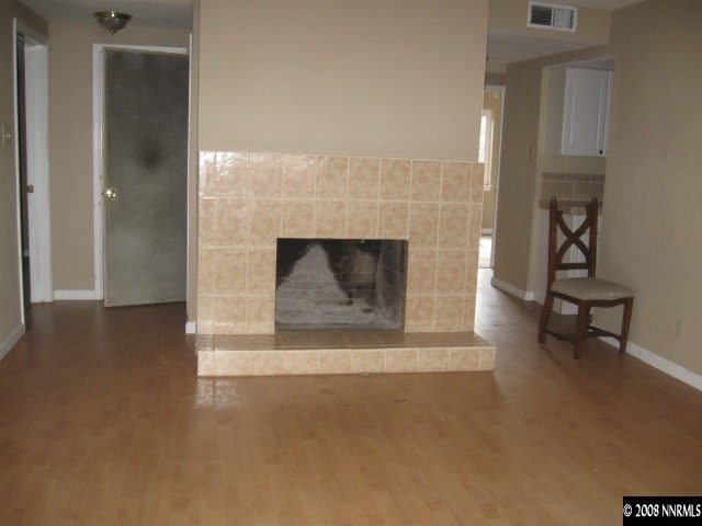 949 Delmar Way Reno, NV 89509 - Photo 4 of 8 a living room with furniture and a fireplace