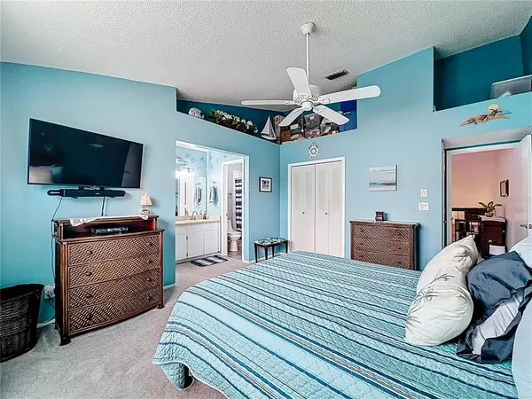 a bedroom with a bed dresser and window