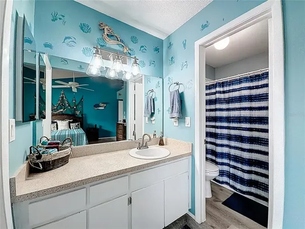 a bathroom with a shower a toilet and a shower