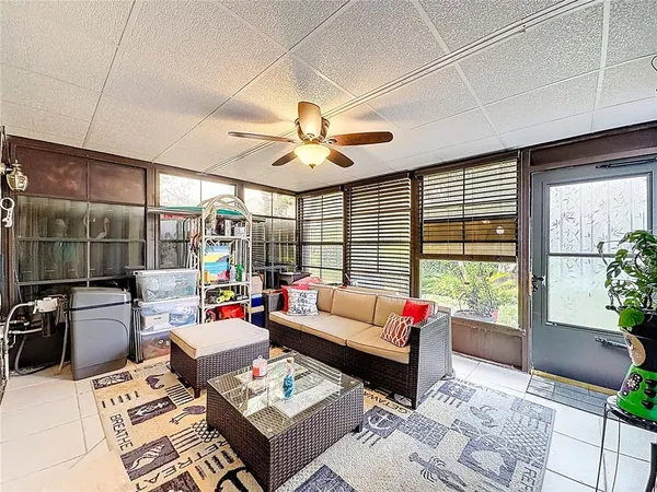 a living room with furniture and a floor to ceiling window