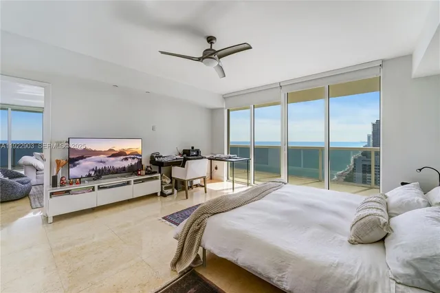 a bedroom with a bed and large window