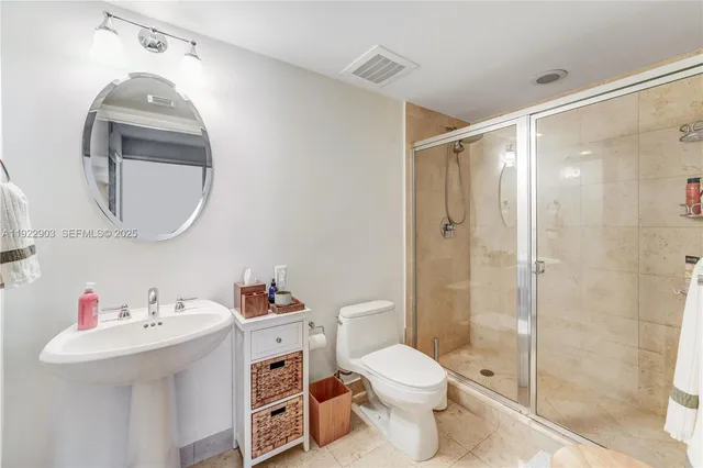 a bathroom with a sink toilet and shower
