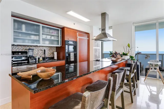 a dining room with furniture and a chandelier