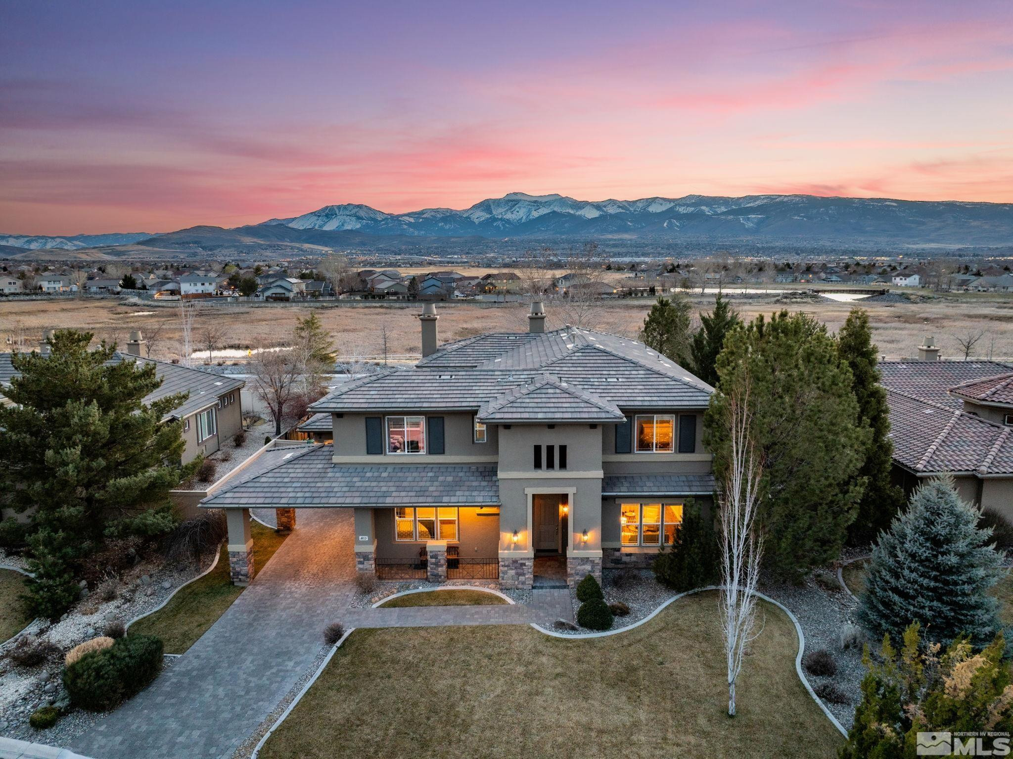 10135 Burghley Lane Reno, NV 89521 - Photo 1 of 39 an aerial view of multiple house with swimming pool and mountain view