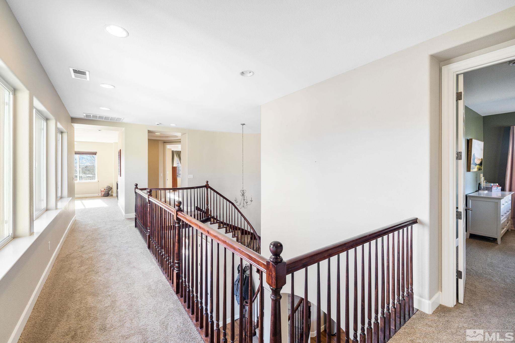 10135 Burghley Lane Reno, NV 89521 - Photo 16 of 39 a view of a hallway with a livingroom and windows