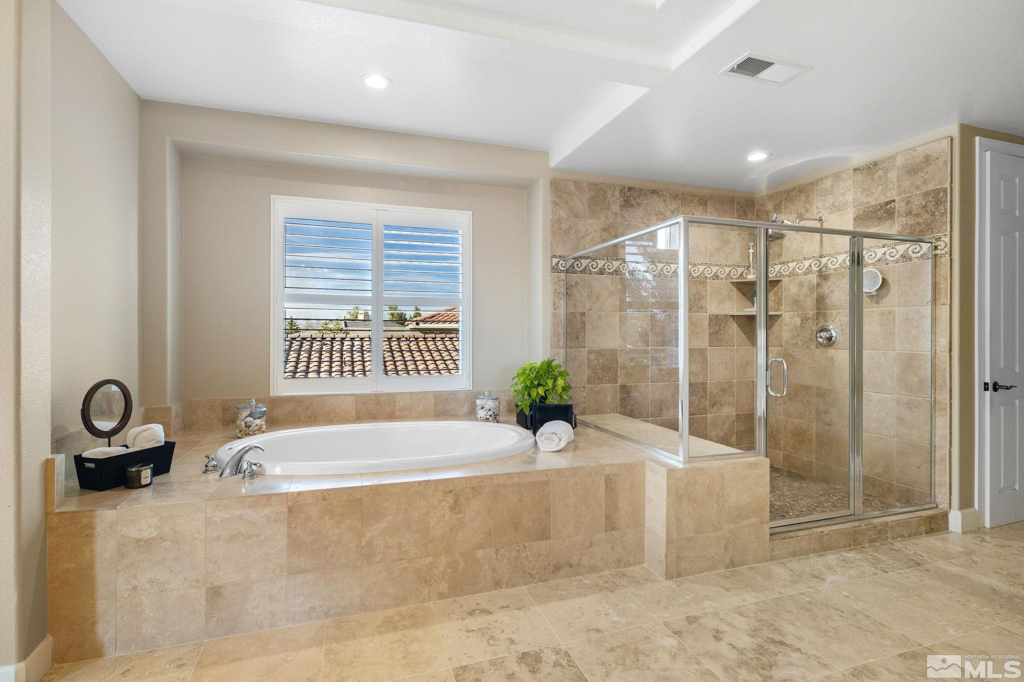 10135 Burghley Lane Reno, NV 89521 - Photo 20 of 39 a spacious bathroom with a tub shower and window