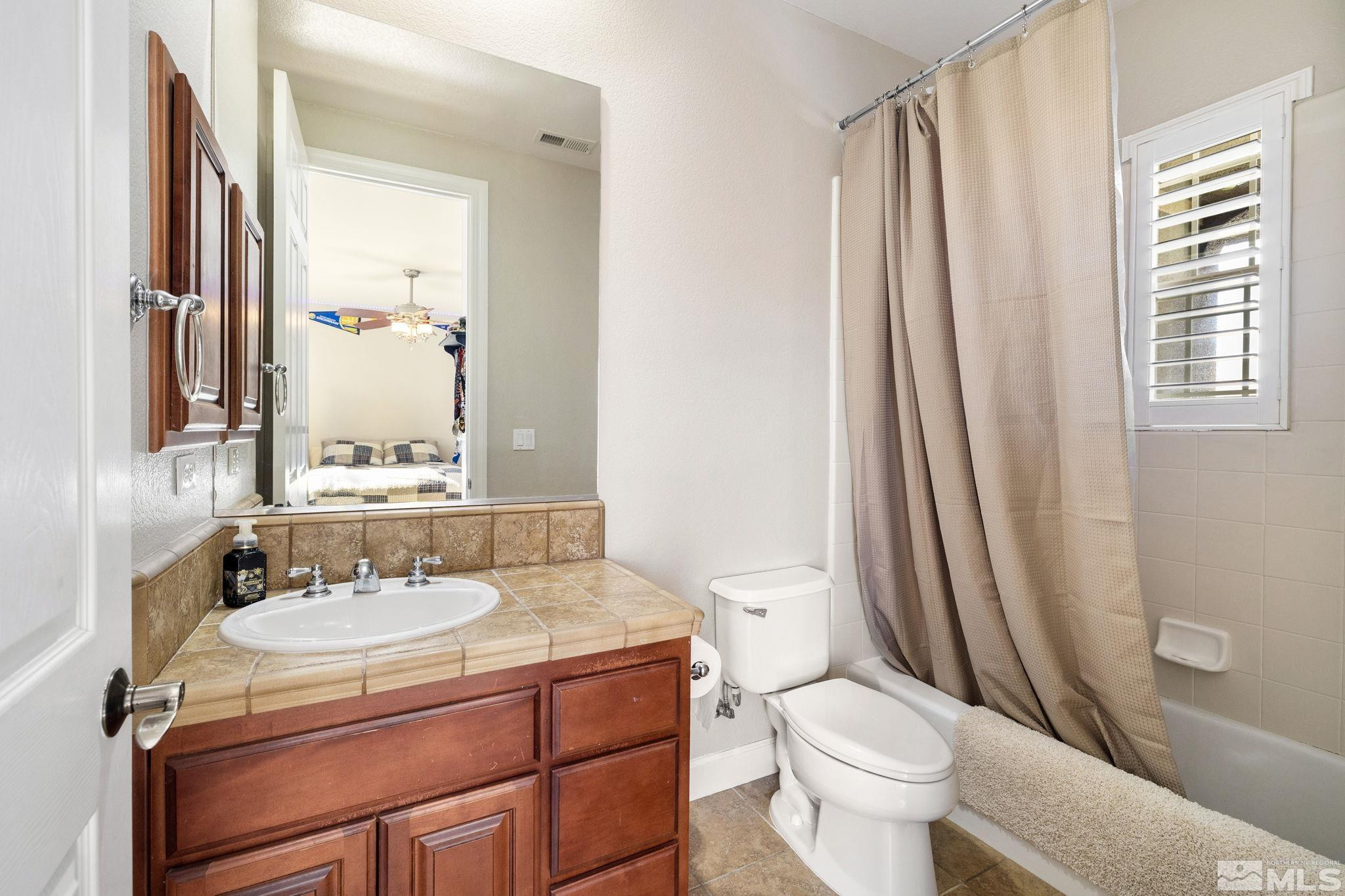 10135 Burghley Lane Reno, NV 89521 - Photo 23 of 39 a bathroom with a sink toilet and shower