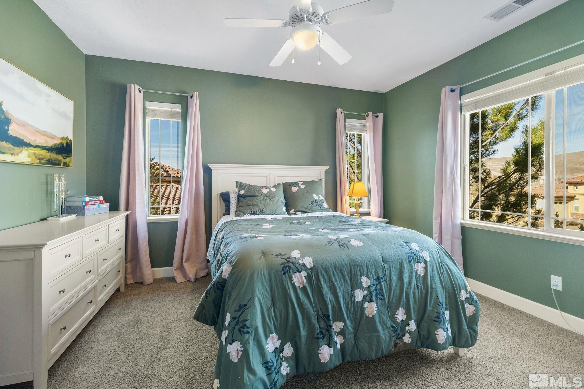 10135 Burghley Lane Reno, NV 89521 - Photo 24 of 39 a bedroom with a bed and large windows