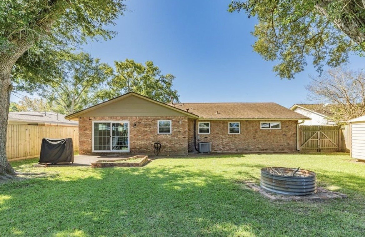 820 Perry Street Angleton, TX 77515 - Photo 5 of 26 a front view of a house with a garden and yard