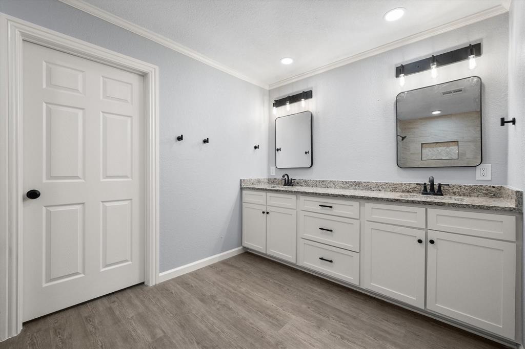 1009 North Spikes Road Corsicana, TX 75110 - Photo 7 of 31 a bathroom with double sink and a mirror