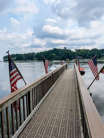 a balcony with wooden floor and city view