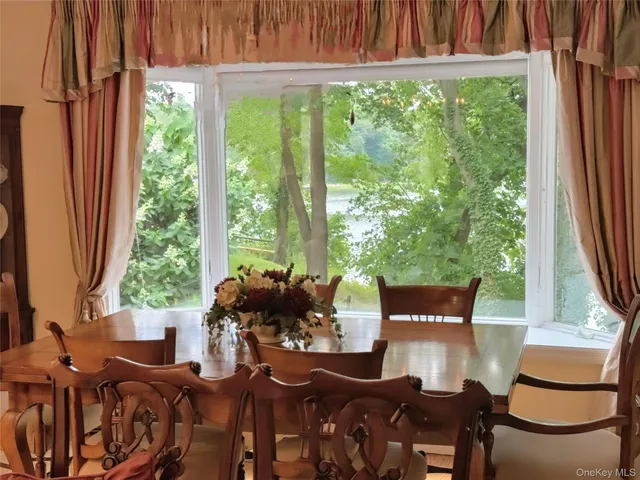 a view of a dining room with furniture window and outside view