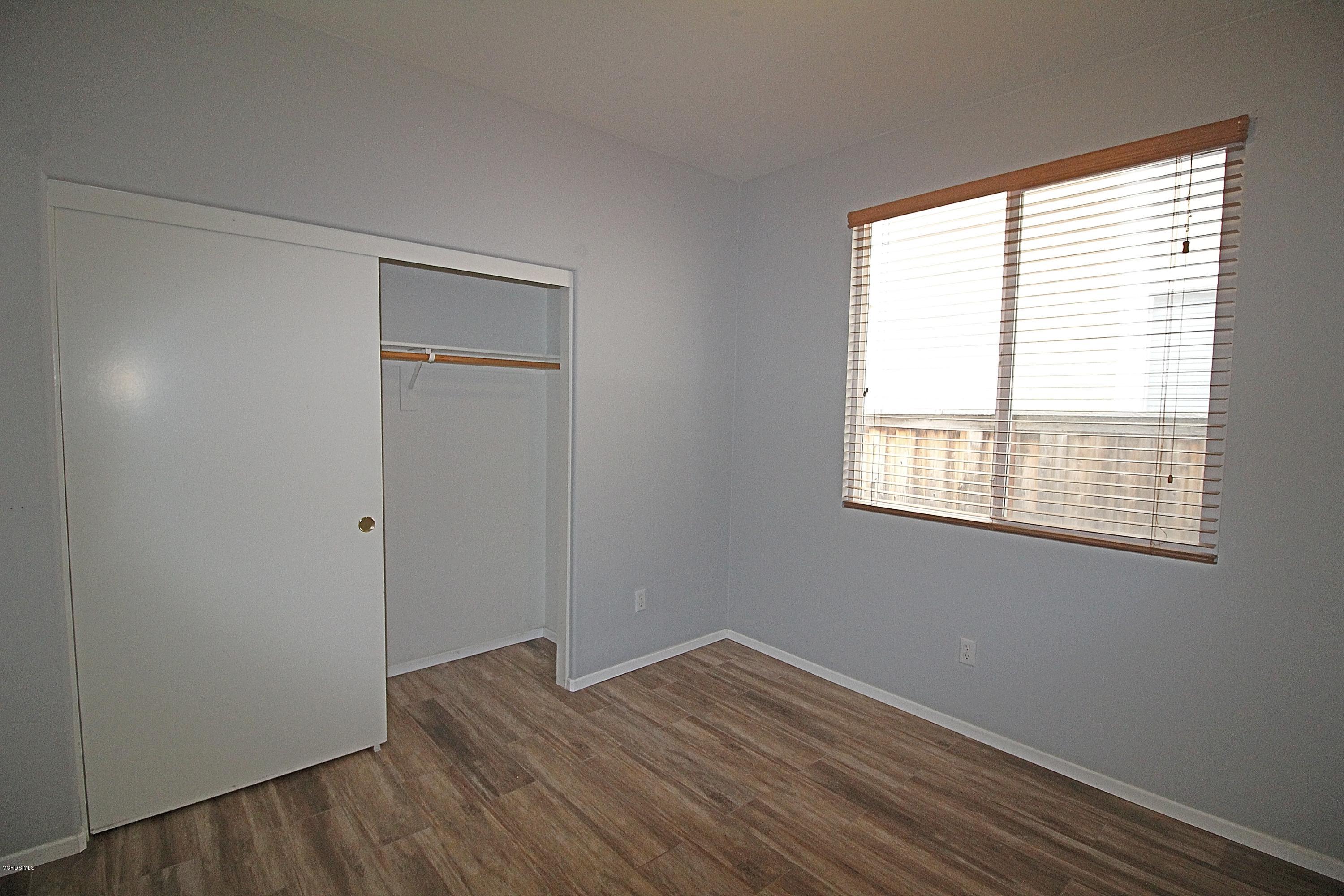 351 Huerta Street Oxnard, CA 93030 - Photo 11 of 18 a view of an empty room with wooden floor and a window