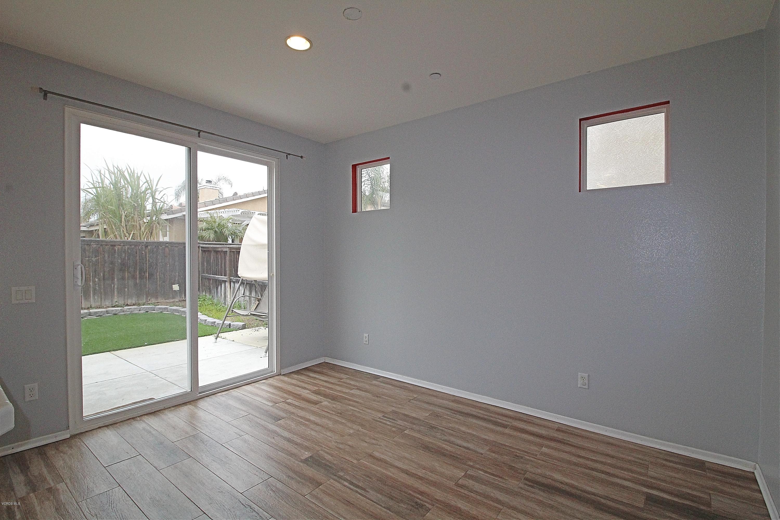 351 Huerta Street Oxnard, CA 93030 - Photo 5 of 18 a view of empty room with wooden floor and fan