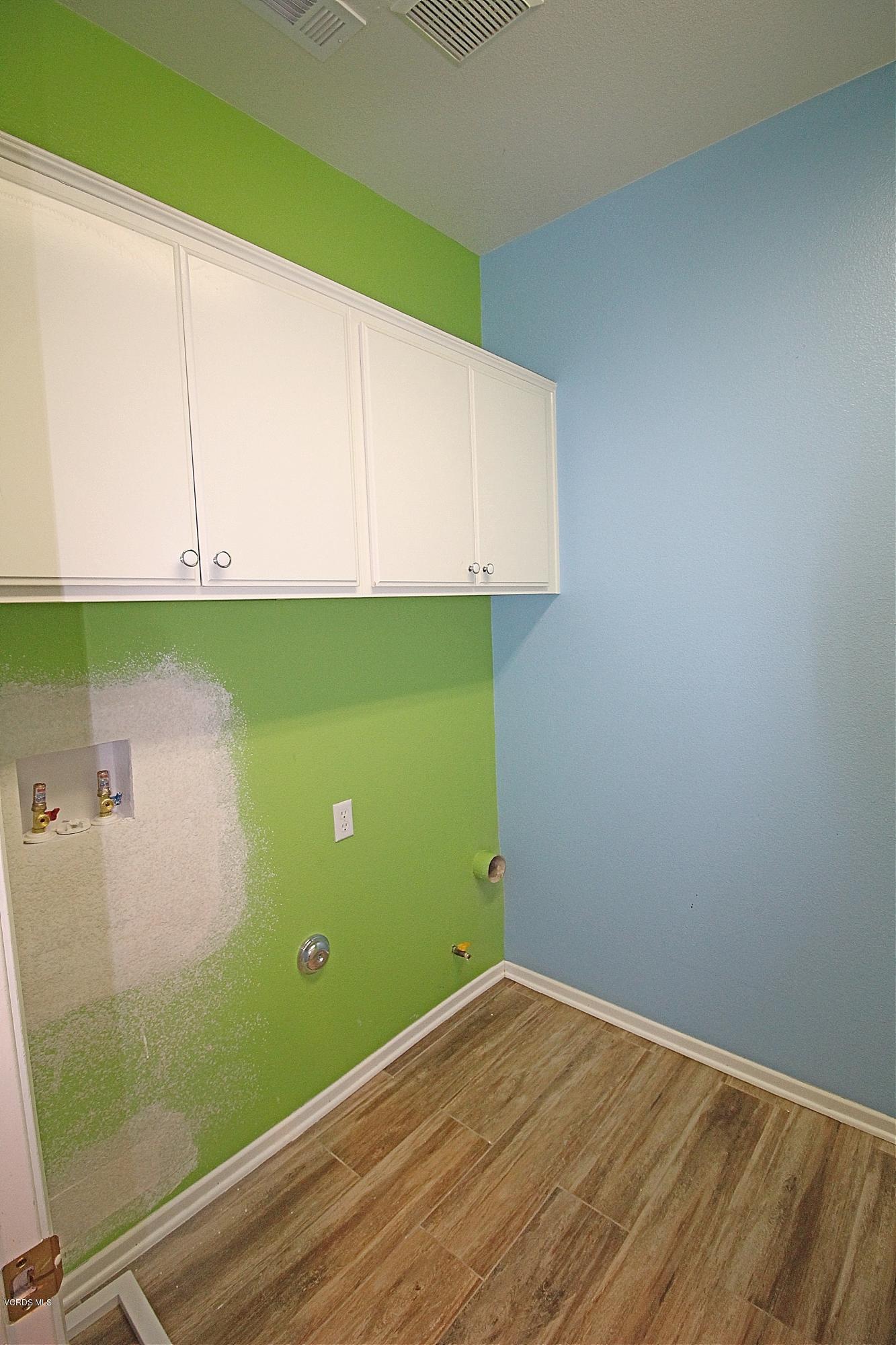 351 Huerta Street Oxnard, CA 93030 - Photo 7 of 18 a view of a room with wooden floor and cabinets