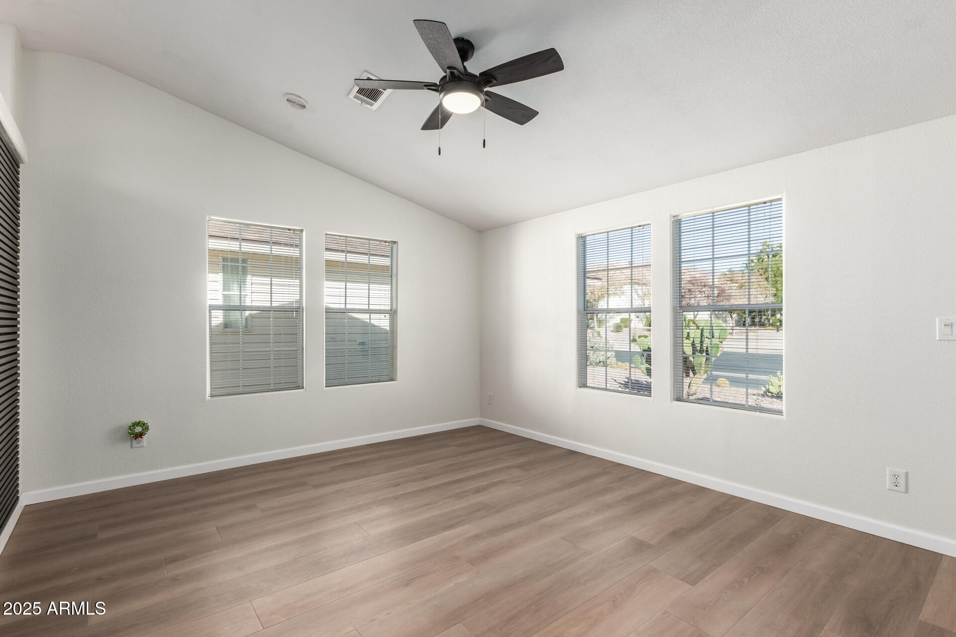 3301 South Goldfield Road, Unit 2006 Apache Junction, AZ 85119 - Photo 14 of 40 a view of an empty room with wooden floor and a window