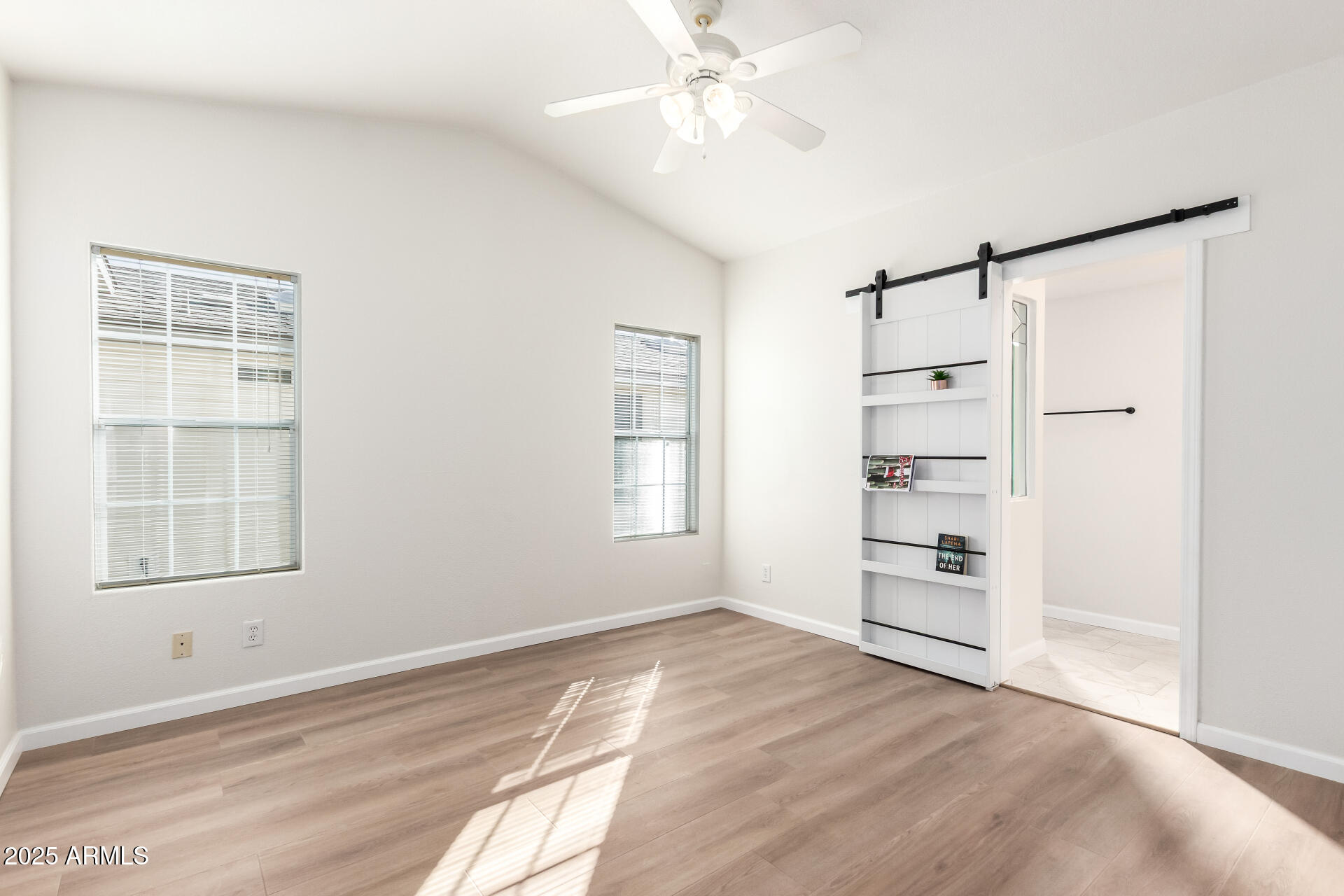 3301 South Goldfield Road, Unit 2006 Apache Junction, AZ 85119 - Photo 18 of 40 a view of empty room with wooden floor and fan