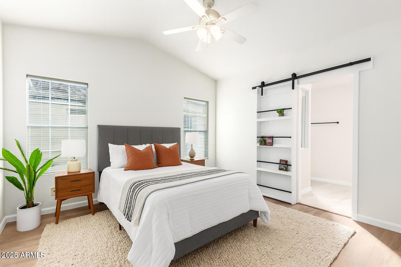 3301 South Goldfield Road, Unit 2006 Apache Junction, AZ 85119 - Photo 5 of 40 a bedroom with a bed and a potted plant
