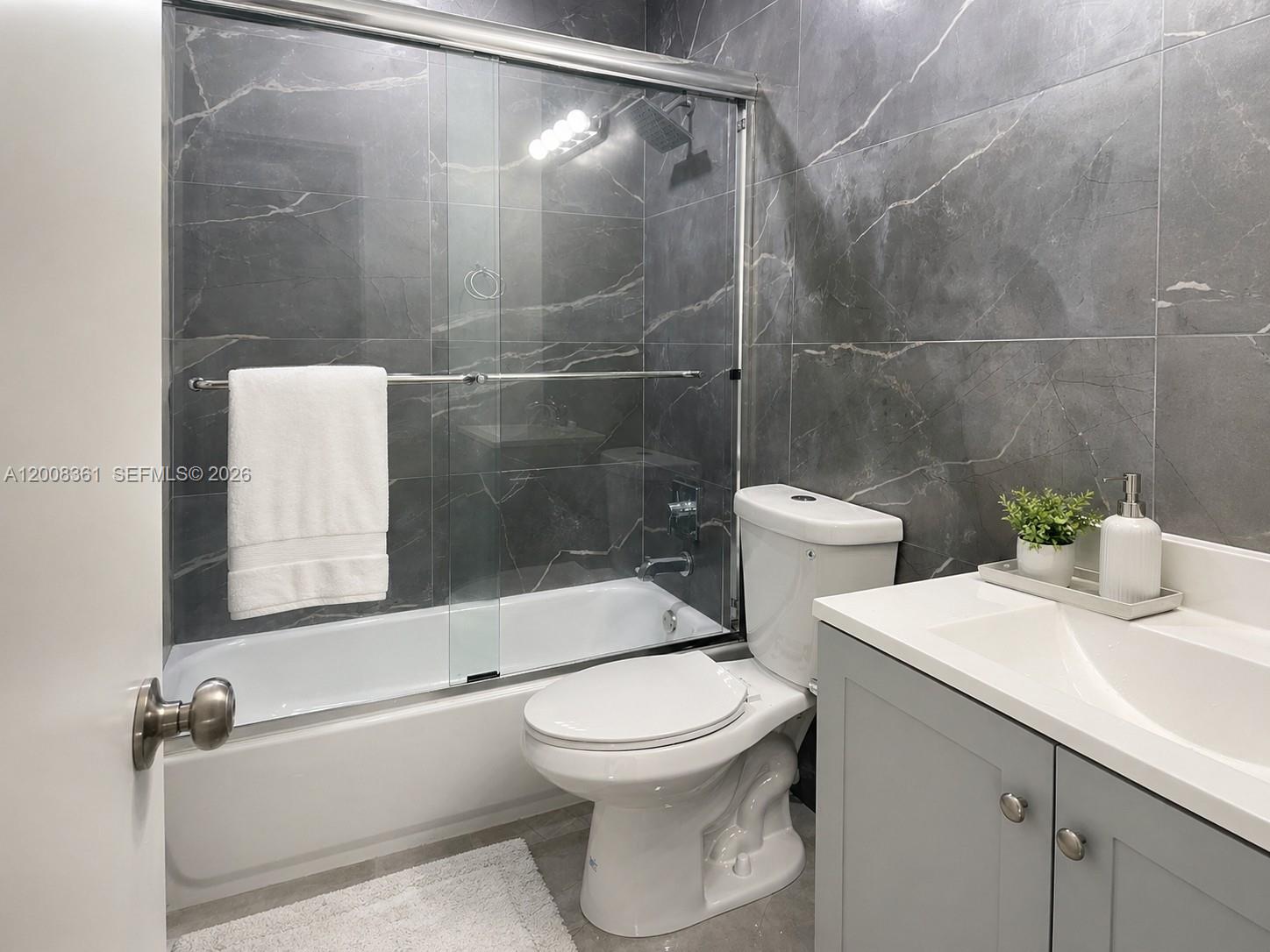 4281 Riverside Drive, Unit 3 Coral Springs, FL 33065 - Photo 6 of 8 a bathroom with a toilet and a shower