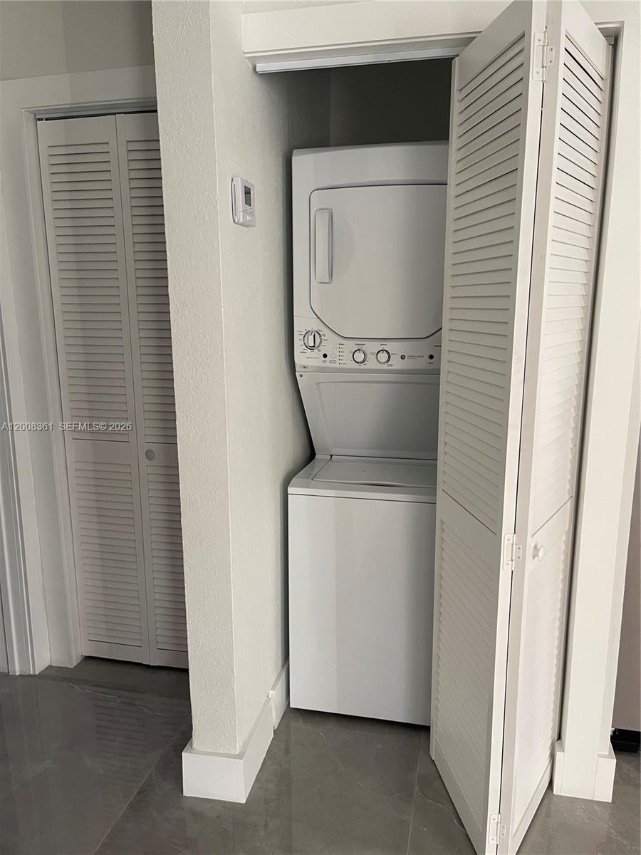 4281 Riverside Drive, Unit 3 Coral Springs, FL 33065 - Photo 7 of 8 a utility room with dryer and washer