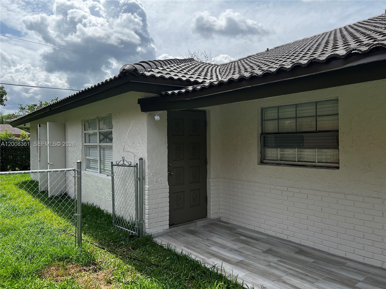 4281 Riverside Drive, Unit 3 Coral Springs, FL 33065 - Photo 8 of 8 a view of a house with a yard