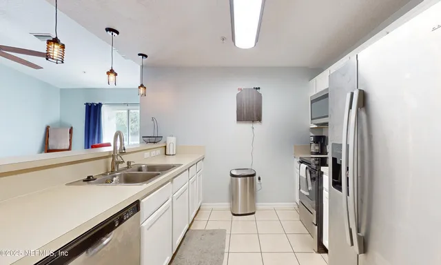 a kitchen with a refrigerator stove and microwave