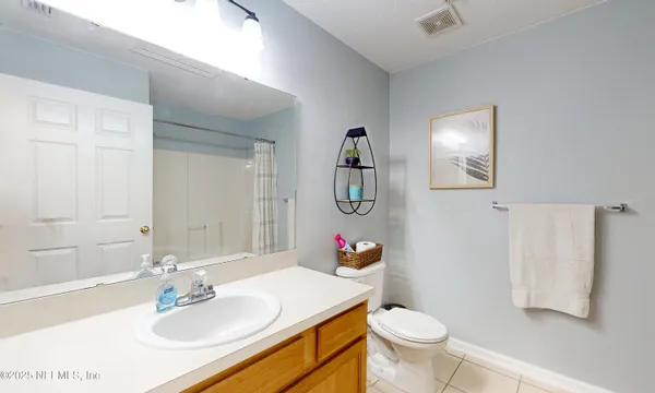 a bathroom with a bathtub shower and toilet