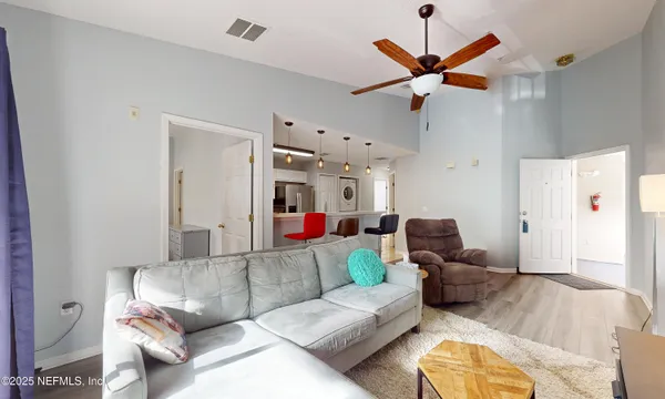 a living room with furniture and wooden floor