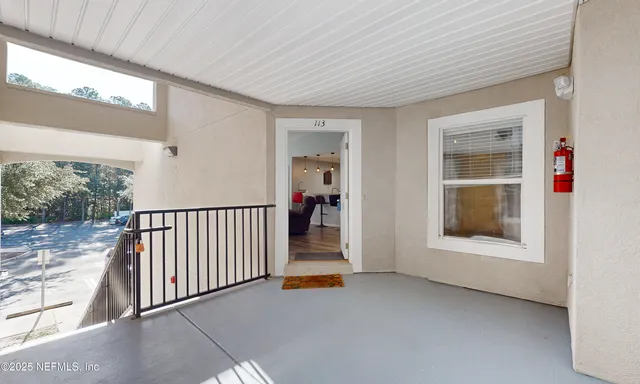 a living room with furniture and a ceiling fan