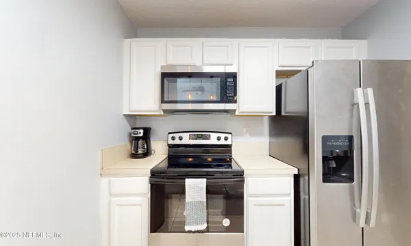 a view of a hallway with washer and dryer