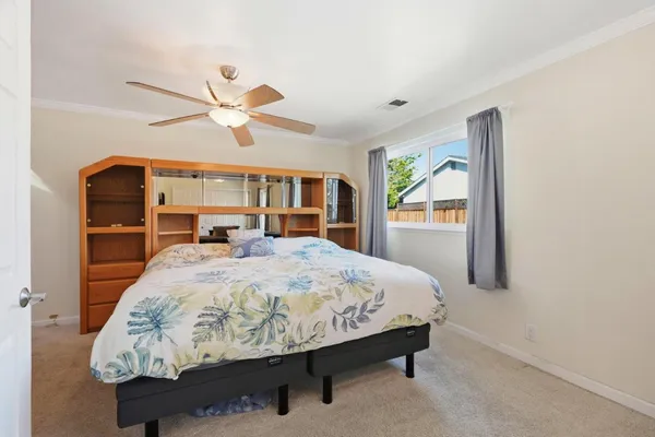 a bedroom with a bed and flat screen tv
