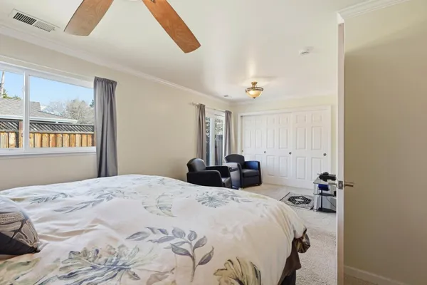 a living room with furniture a flat screen tv and a window