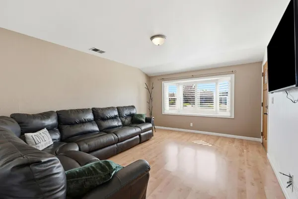 a living room with furniture a window and a table