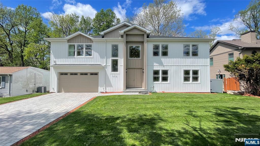 405 Valley Road River Edge, NJ 07661 - Photo 1 of 20 a front view of a house with a garden and yard