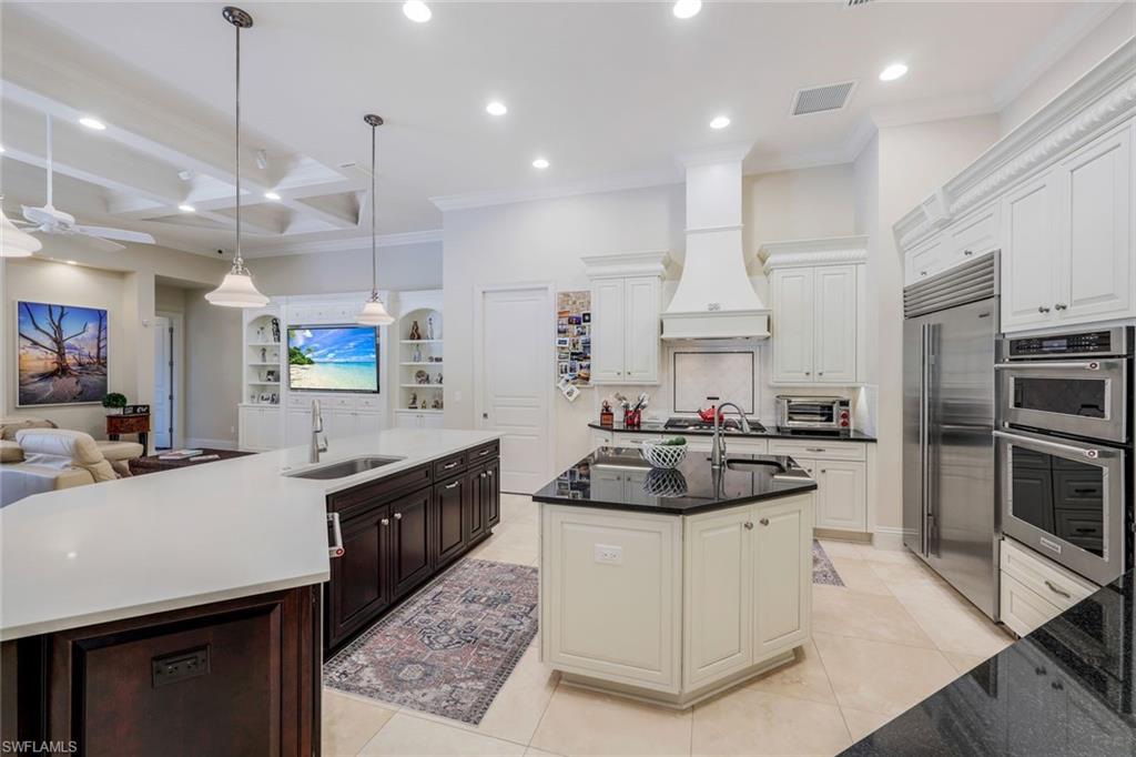 9243 Marble Stone Drive Naples, FL 34120 - Photo 12 of 50 a kitchen with stainless steel appliances granite countertop a sink stove and refrigerator