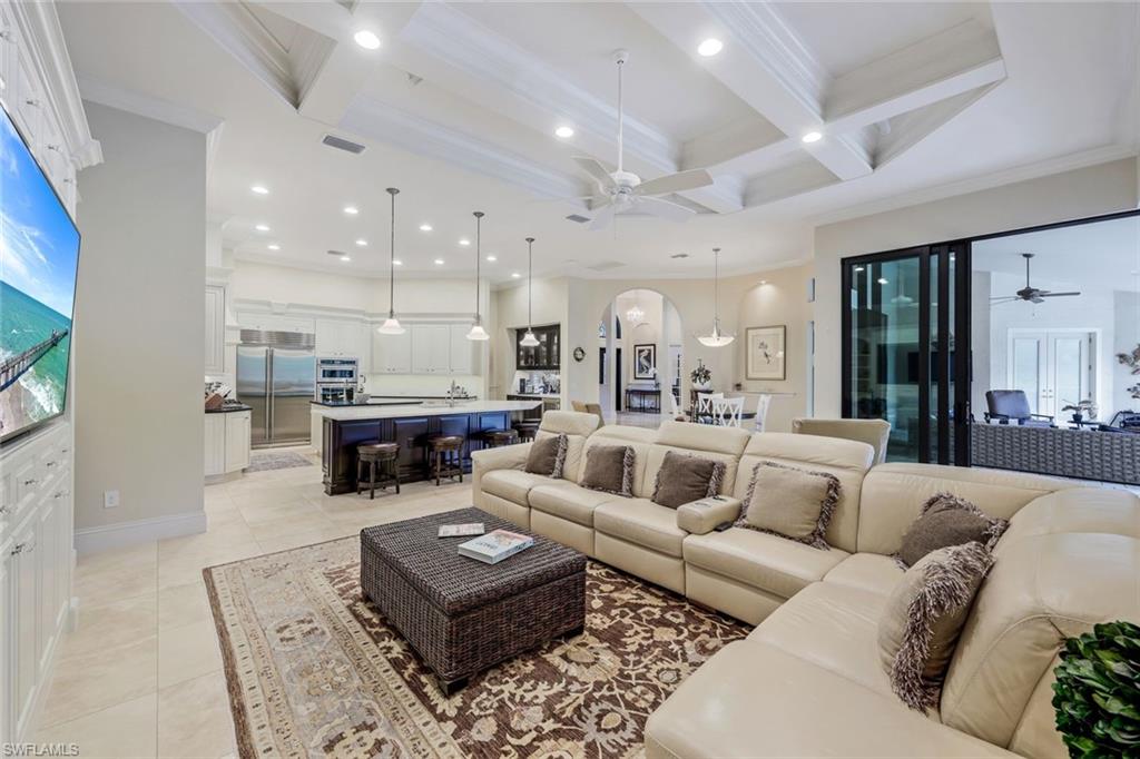 9243 Marble Stone Drive Naples, FL 34120 - Photo 16 of 50 a living room with furniture kitchen view and a chandelier