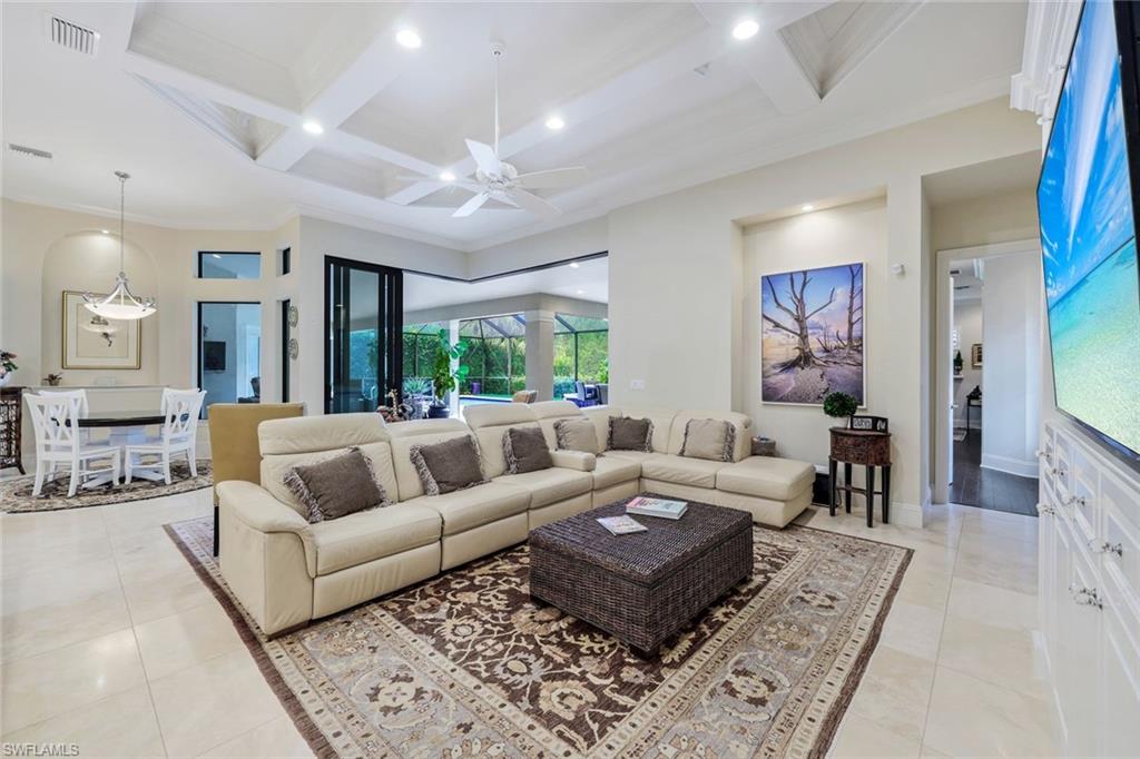 9243 Marble Stone Drive Naples, FL 34120 - Photo 18 of 50 a living room with furniture and a flat screen tv