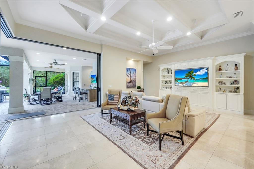 9243 Marble Stone Drive Naples, FL 34120 - Photo 20 of 50 a living room with furniture and a flat screen tv
