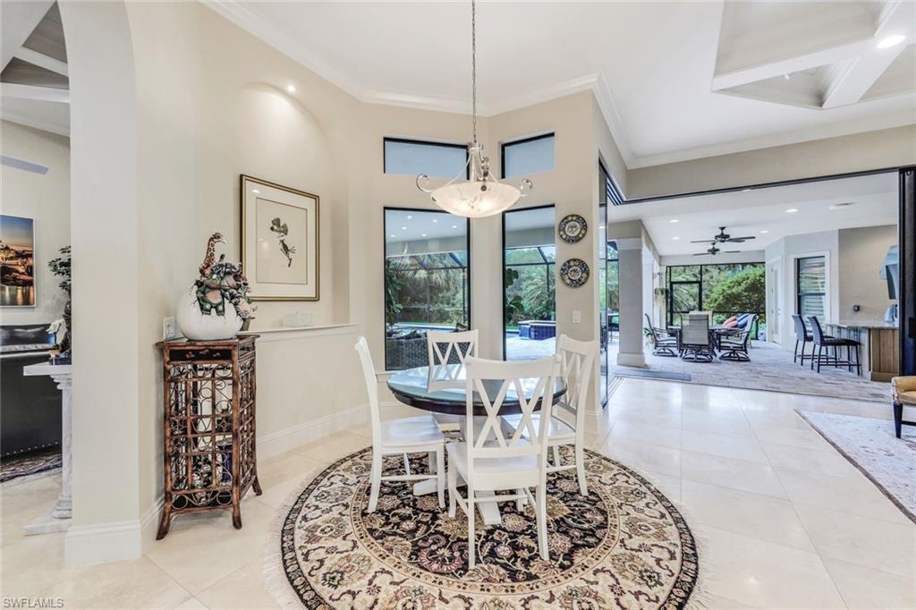 9243 Marble Stone Drive Naples, FL 34120 - Photo 21 of 50 a view of a dining room with furniture