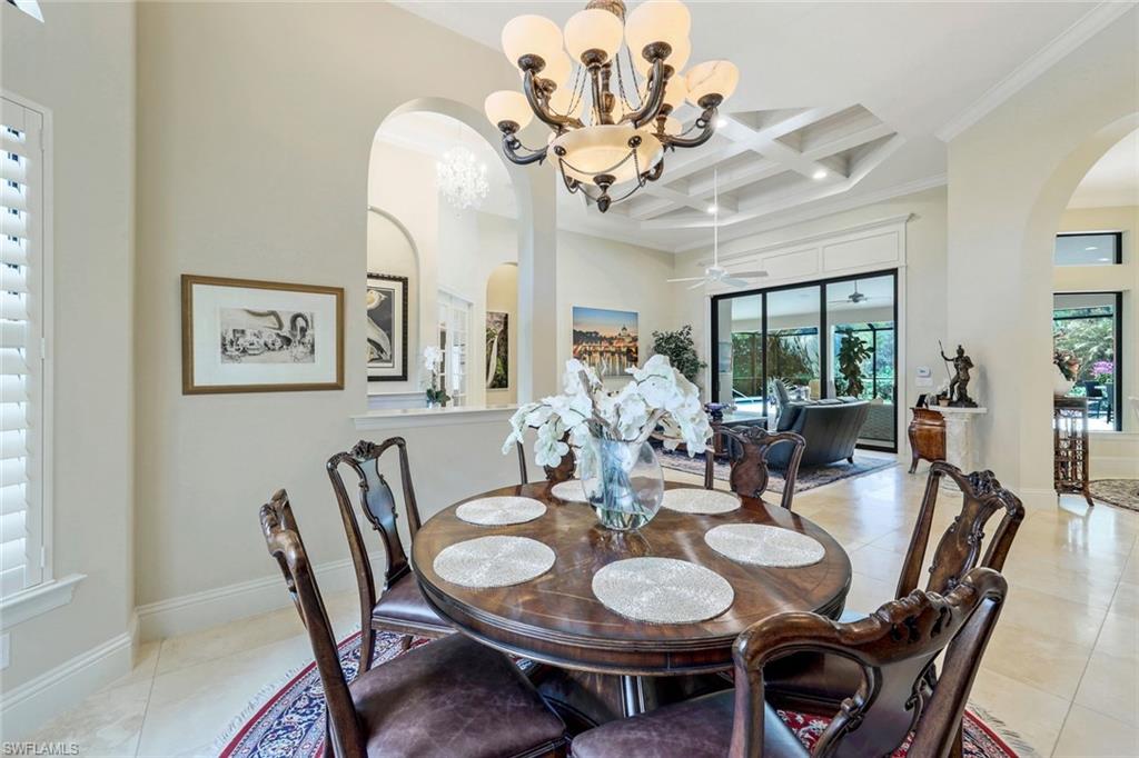 9243 Marble Stone Drive Naples, FL 34120 - Photo 24 of 50 a view of a dining room with furniture a chandelier and wooden floor