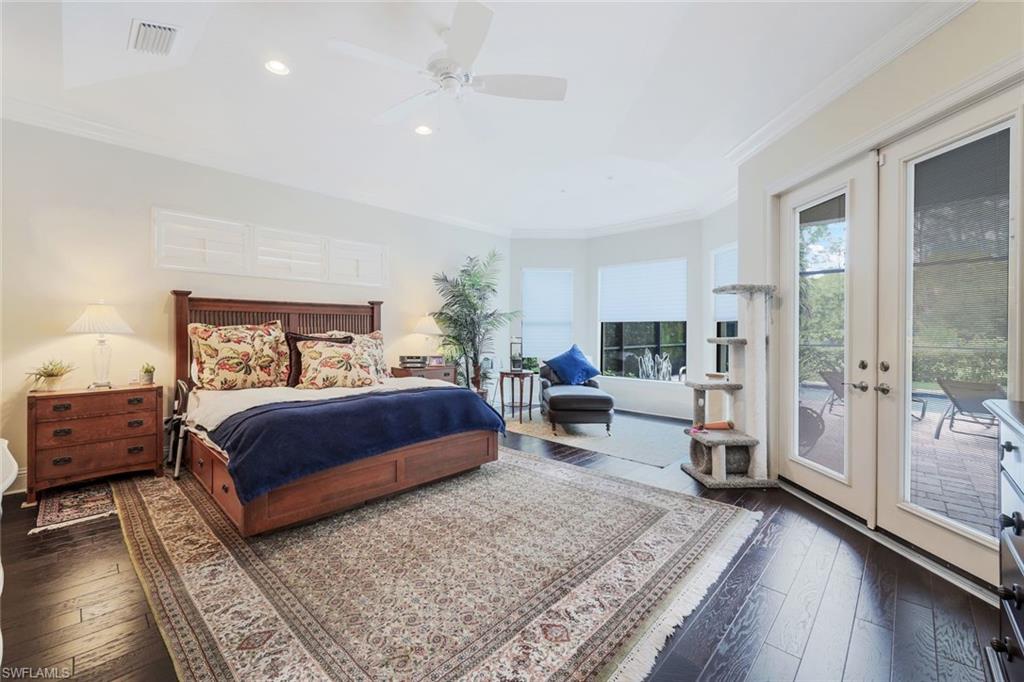 9243 Marble Stone Drive Naples, FL 34120 - Photo 25 of 50 a bedroom with a bed couch and a window