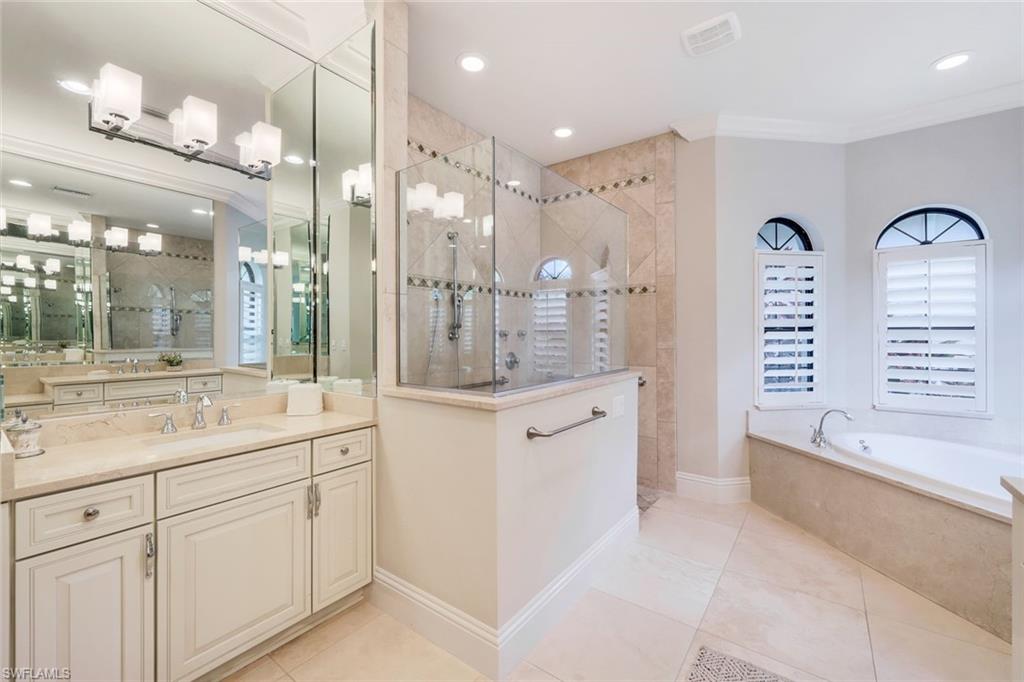 9243 Marble Stone Drive Naples, FL 34120 - Photo 28 of 50 a spacious bathroom with a shower a sink and a large mirror